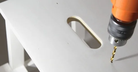 Closeup of a drill bit drilling a hole in a wooden plank Video stock 105428578