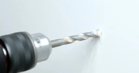 Closeup of a drill bit drilling a hole in a wall Stock Footage 108516337