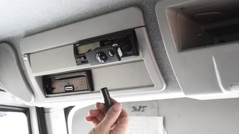 Closeup of a driver changing a roll of paper in a tachograph. Paper roll Stock Footage 169746763
