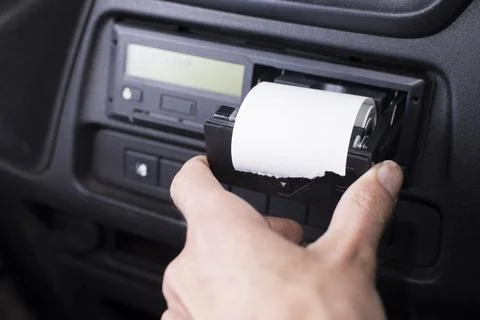 Closeup of a driver changing a roll of paper in a tachograph. Paper roll Stock Photos