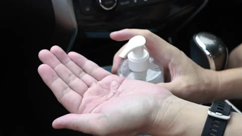 Closeup driver hands cleaning preventing virus with alcohol gel inside car Stock Footage 152518747