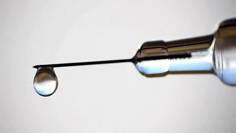 Closeup droplets of clear liquid fall and spurt from syringe. medication Stock-Footage 336587251
