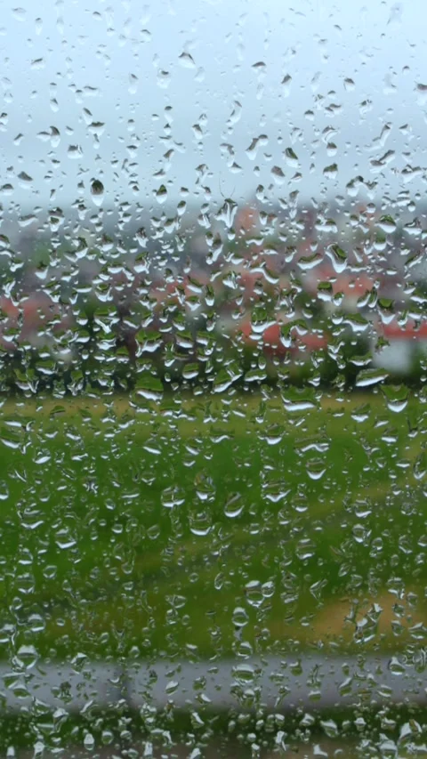 Closeup Droplets Of Rain Running Down Glass Window On Cloudy Day Stock Footage 240753745
