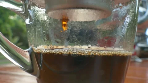 Closeup drops of Vietnamese coffee from drip cup Stock Footage 132310110