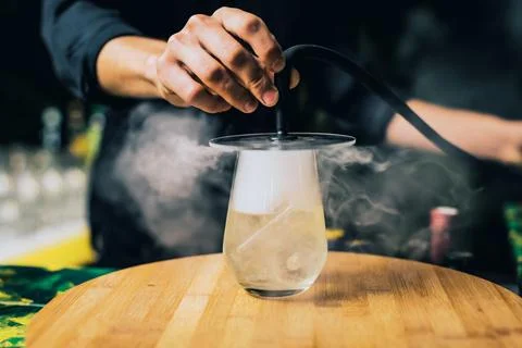A closeup of the dry smoke cocktail, Trago ahumado, smokie drink, barman, bar Stock Photos