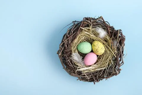 Closeup of easter egg nest flat lay. Stock Photos