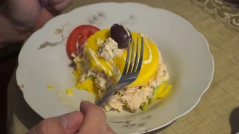 Closeup eating a plate of Causa de Peru of crab pulp with tomato Stock Footage 154814573