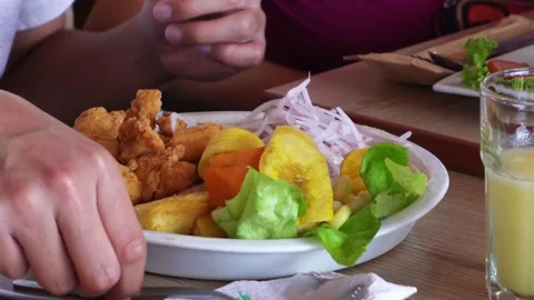 Closeup eating a plate of ceviche with fried fish and fried banana with sweet Stock Footage 167370500