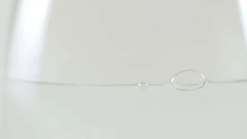 Closeup of an Effervescent Tablet Falling into a Glass of Water Stock Footage 74608162