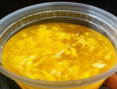 Closeup of the egg drop soup inside a plastic container Stock Photos