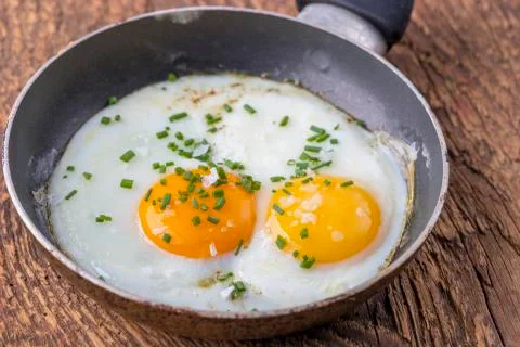 Closeup of a egg in a pan Stock Photos