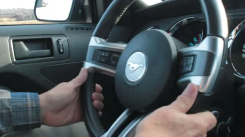 Closeup of an Elderly Man's Hands Driving a Ford Mustang Stock Footage 44666873