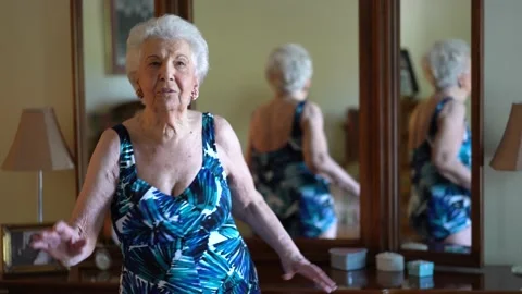 Closeup of elderly woman modeling a bathing suit she uses in water aerobics Stock Footage 140743549