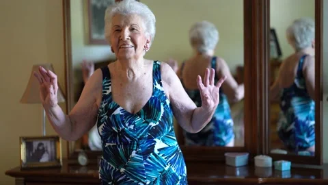 Closeup of elderly woman modeling a bathing suit she uses in water aerobics Stock Footage 140743664