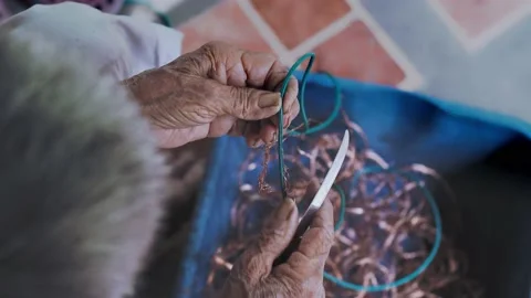 Closeup of elderly wrinkling hands remove copper from old wires plastic cover. Stock Footage 147262243