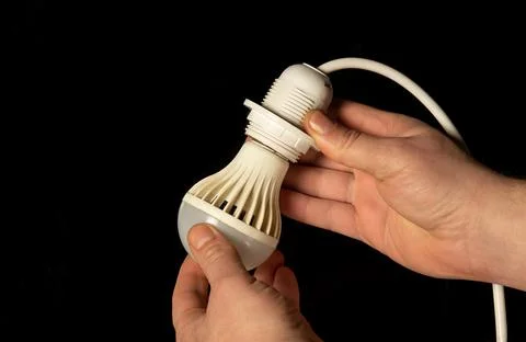Closeup of an electrician hands installing an electric energy-saving light Stock Photos