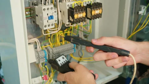 Closeup. Electricians hands testing current electric in control panel Stock Footage 158897774