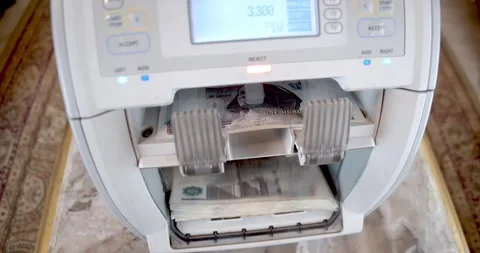 Closeup of Electronic Cash Counting Machine Counting 100 Egyptian Pounds Notes Stock Footage 317922717