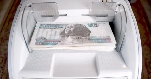 Closeup of Electronic Cash Counting Machine for 100 Egyptian Pound Notes Stock-Footage 317925262