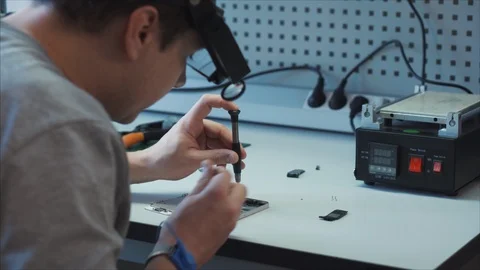 Closeup electronic expert identifies the cause of the breakdown of the gadget Video stock 105971073
