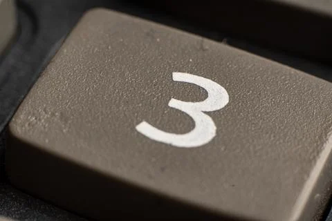 Closeup of electronic keypad displaying the number three for calculations in Stock Photos