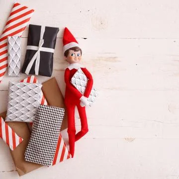 Closeup of Elf with advent presents on white wooden background. Christmas Stock Photos