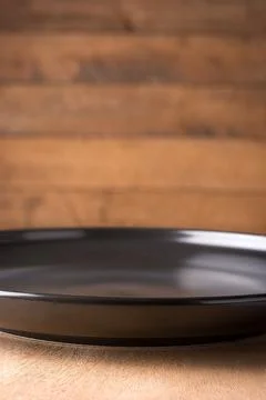 Closeup empty black plate, background Stock Photos