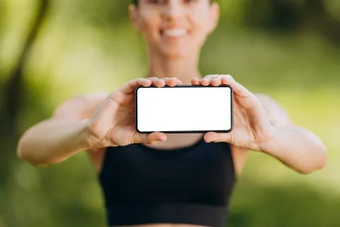 Closeup empty blank white screen in female hands. - Image Stock Photos