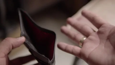 Closeup of Empty Wallet in Hands Showing Financial Crisis and Money Shortage Stock Footage 340802692