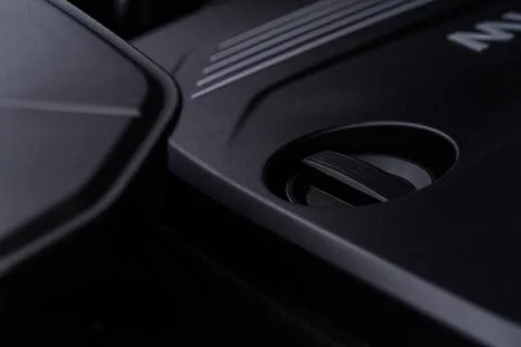 Closeup engine oil cap in engine room of a modern car. Oil cap on the car eng Stock Photos