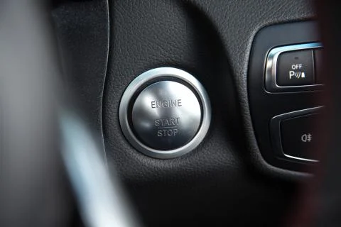 Closeup of a [ENGINE START/STOP] button of a black luxury car Stock Photos