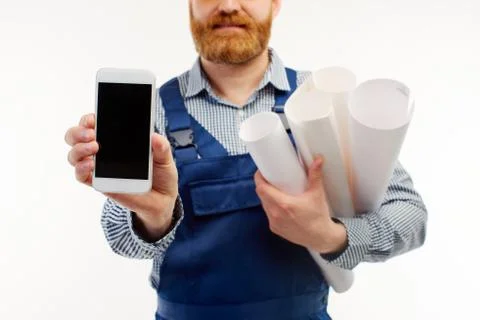 Closeup. The engineer shows the phone to the camera on a white background. Stock Photos