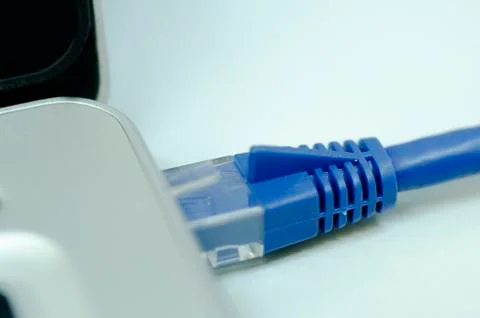 Closeup ethernet cable connected to the Lan port on laptop for computer netwo Stock Photos