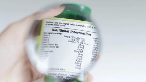 Closeup of examining nutritional information label Stock Footage 121888709