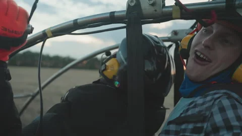 Closeup excited man gripping paramotor cage as engine revs before takeoff Stock Footage 317196172