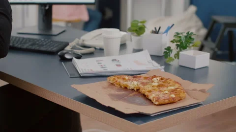 Closeup of executive manager taking slice of pizza eating in front of computer Video stock 155492136