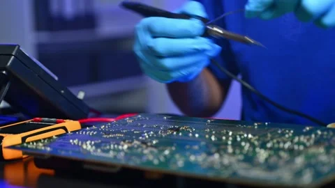 Closeup of expert soldering a green PCB board using precision tools. Ideal .. Stock Footage 312774022