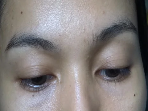 Closeup Eyelid and Half Face of an Asian Woman Face Stock Footage 241634965