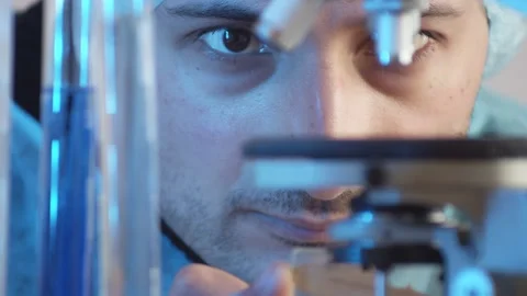 Closeup on the eyes. The laboratory assistant puts the object of study on the mi Stock Footage 233031133