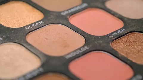Closeup of a eyeshadow palette container as the brush takes the powder. Stock Footage 127500004