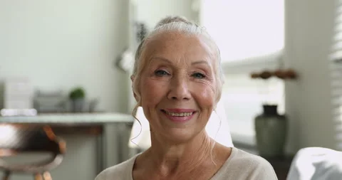 Closeup face of 65s happy elderly woman looking at camera Stock Footage 145132749