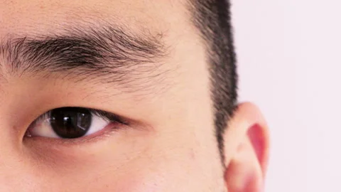 Closeup, face and eye with optometry, retina examination or glaucoma test in Video stock 334760399