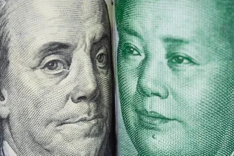 Closeup face to face of Benjamin Franklin and Mao tse tung Stock Photos