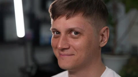 Closeup face of handsome positive man having his eyebrows waxed by beautician in Stock Footage 287850854
