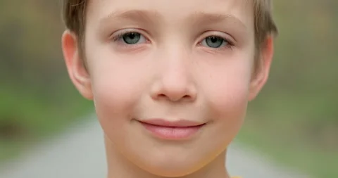 Closeup face of  little boy looking to camera on the nature.  White boy of 8  Stock Footage 130838653