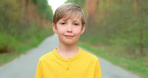 Closeup face of  little boy looking to camera on the nature.  White boy of 8  Stock Footage 149246826
