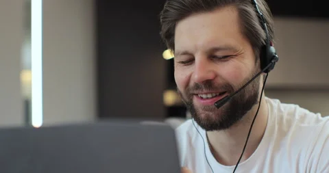 Closeup face man wearing headset and talking, call center worker. Positive young Stock Footage 269139972