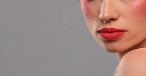 Closeup face of a model with bright eye makeup looking to the camera. Woman m Stock Footage 125292978