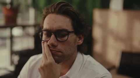 Closeup face of pensive Caucasian man in eyeglasses feeling stressed and Stock Footage 343365981