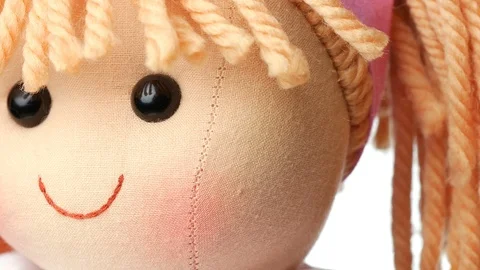 Closeup face rag doll smiling on a white background Stock Footage 122974717